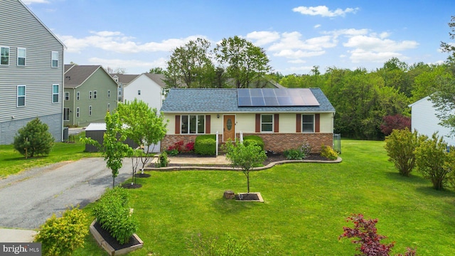 10100 Lewis Dr, Damascus, MD 20872 - ranch-style home with brick siding, solar panels, a front lawn, driveway, and roof with shingles