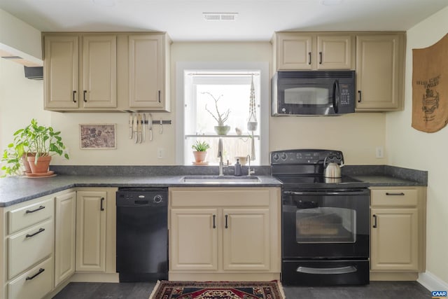 304 NW 11th St, Charlottesville, VA 22903 - kitchen with black appliances, a sink, cream cabinetry, and dark countertops