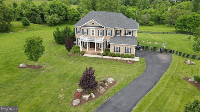 18604 Wild Raspberry Dr, Purcellville, VA 20132 - view of front of home with asphalt driveway, a porch, a shingled roof, and stone siding