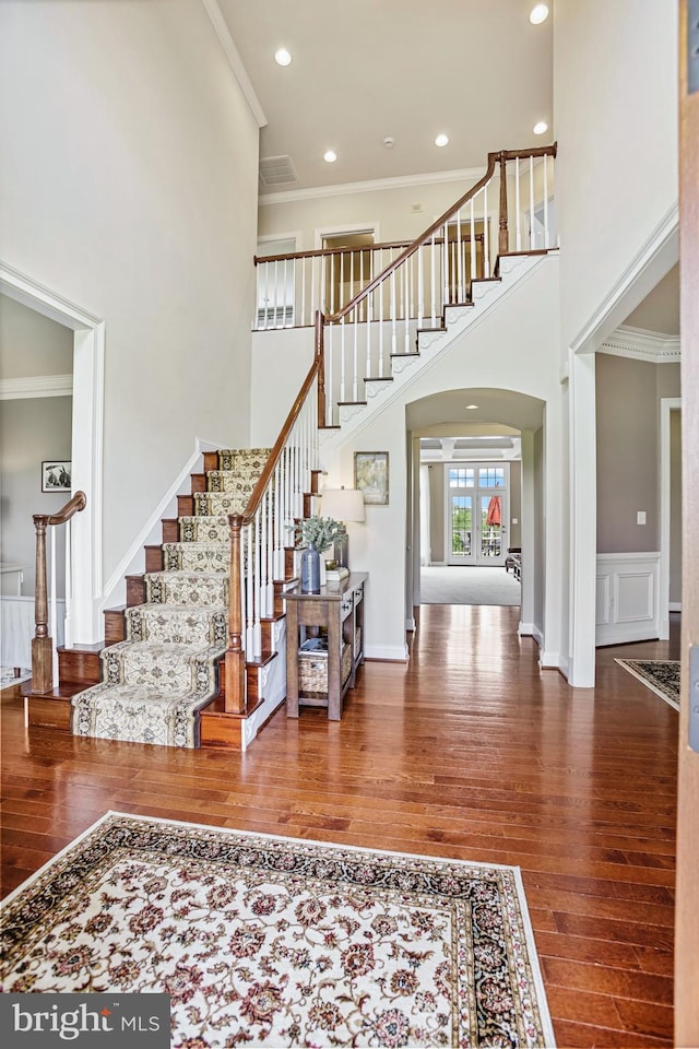 18604 Wild Raspberry Dr, Purcellville, VA 20132 - entryway featuring hardwood / wood-style floors, stairway, a high ceiling, crown molding, and arched walkways