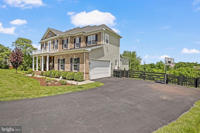 18604 Wild Raspberry Dr, Purcellville, VA 20132 - colonial-style house featuring driveway, brick siding, a garage, a balcony, and a gate