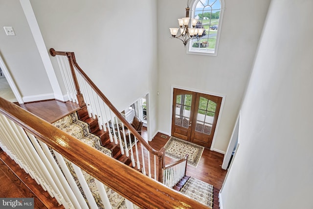 18604 Wild Raspberry Dr, Purcellville, VA 20132 - foyer featuring a chandelier, dark wood finished floors, a high ceiling, stairs, and baseboards