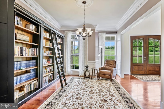 18604 Wild Raspberry Dr, Purcellville, VA 20132 - sitting room with a chandelier, wood finished floors, ornamental molding, wainscoting, and french doors