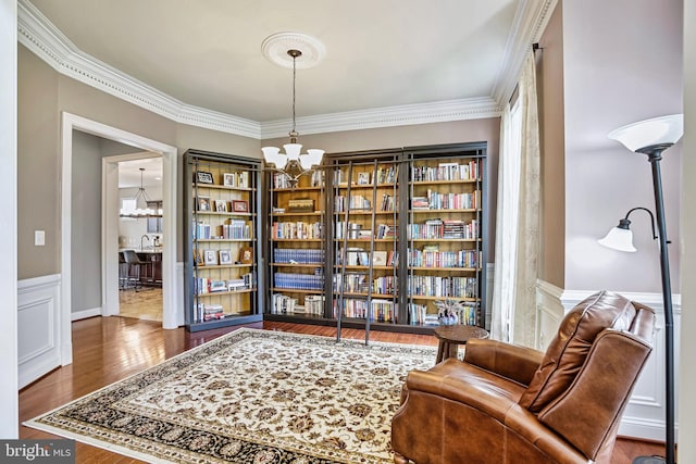 18604 Wild Raspberry Dr, Purcellville, VA 20132 - sitting room featuring a chandelier, ornamental molding, a wainscoted wall, and dark wood-style floors
