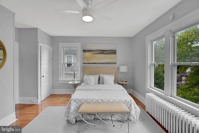 4316 9th St NW, Washington, DC 20011 - bedroom featuring radiator heating unit, baseboards, light wood-style floors, and a ceiling fan
