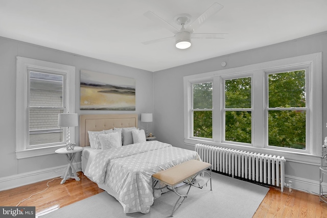 4316 9th St NW, Washington, DC 20011 - bedroom featuring radiator heating unit, wood finished floors, baseboards, and a ceiling fan