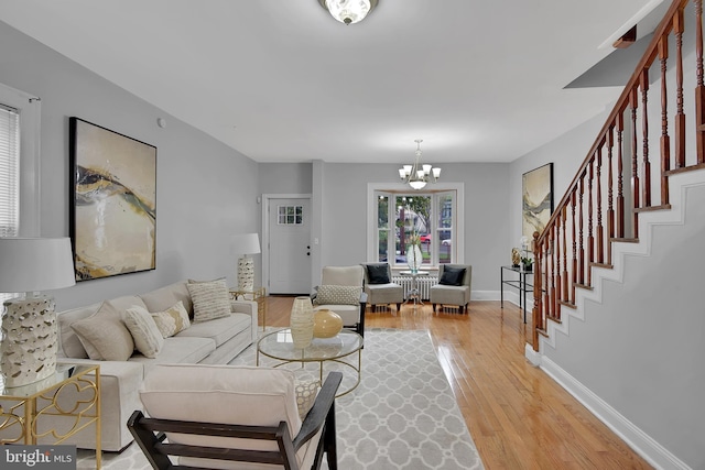 4316 9th St NW, Washington, DC 20011 - living room featuring a chandelier, light wood-style flooring, stairs, and baseboards