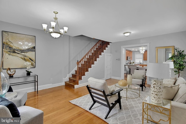 4316 9th St NW, Washington, DC 20011 - living room featuring a chandelier, stairs, light wood-style floors, and baseboards