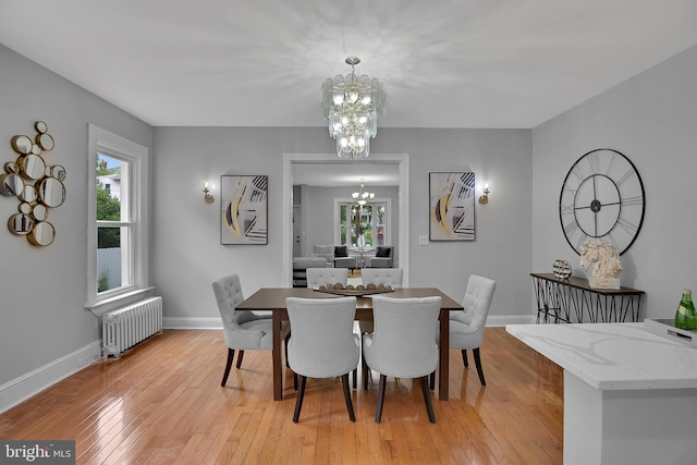 4316 9th St NW, Washington, DC 20011 - dining area with radiator heating unit, a chandelier, baseboards, and light wood-style floors