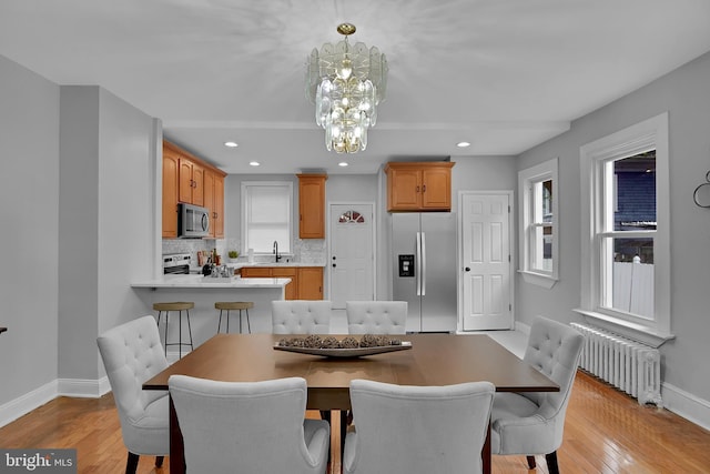 4316 9th St NW, Washington, DC 20011 - dining space with radiator, baseboards, a chandelier, light wood-type flooring, and recessed lighting