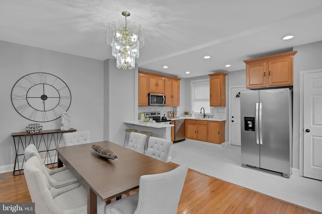 4316 9th St NW, Washington, DC 20011 - dining room with light wood-type flooring, a chandelier, and recessed lighting