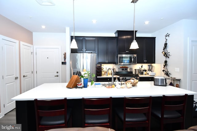 10401 Resort Rd Unit F, Ellicott City, MD 21042 - kitchen featuring appliances with stainless steel finishes, open shelves, a center island with sink, light countertops, and recessed lighting