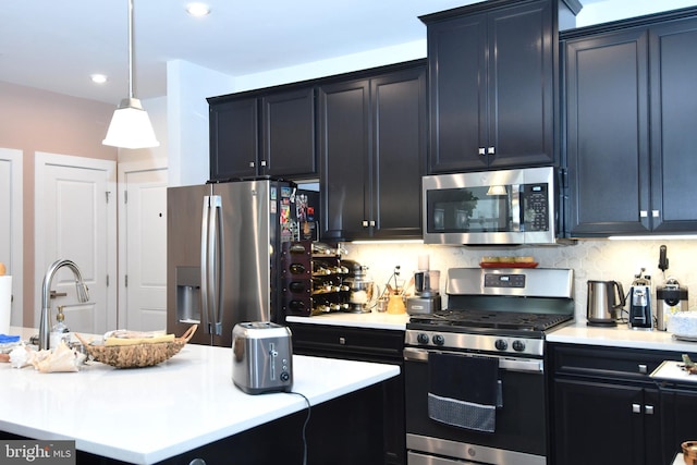 10401 Resort Rd Unit F, Ellicott City, MD 21042 - kitchen with appliances with stainless steel finishes, light countertops, a sink, hanging light fixtures, and dark cabinetry