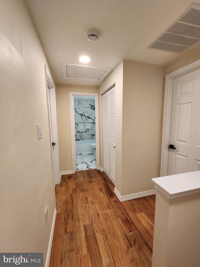 7331 Branchwood Ter, Clinton, MD 20735 - corridor with attic access, wood finished floors, and baseboards