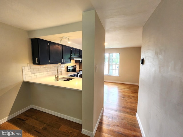 7331 Branchwood Ter, Clinton, MD 20735 - kitchen featuring stainless steel electric range, a sink, dark cabinetry, backsplash, and dark wood-style flooring