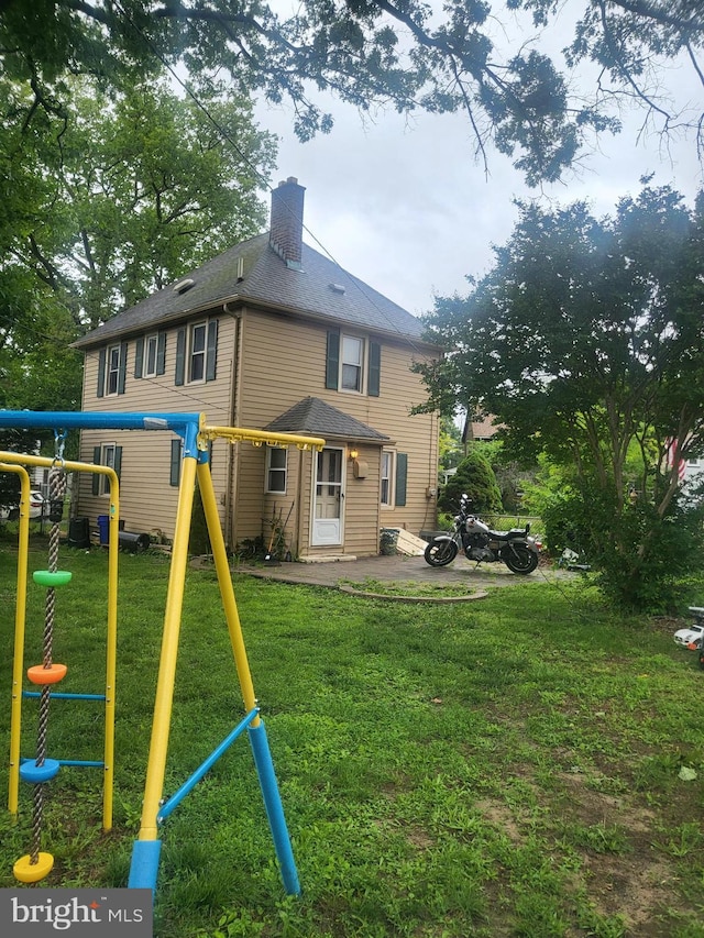 230 New Jersey Rd, Brooklawn, NJ 08030 - rear view of property with a playground, a chimney, a patio area, and a lawn