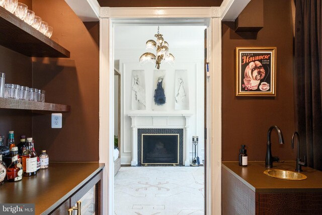 1901 Wyoming Ave NW Unit 40, Washington, DC 20009 - indoor wet bar with a tiled fireplace and a chandelier