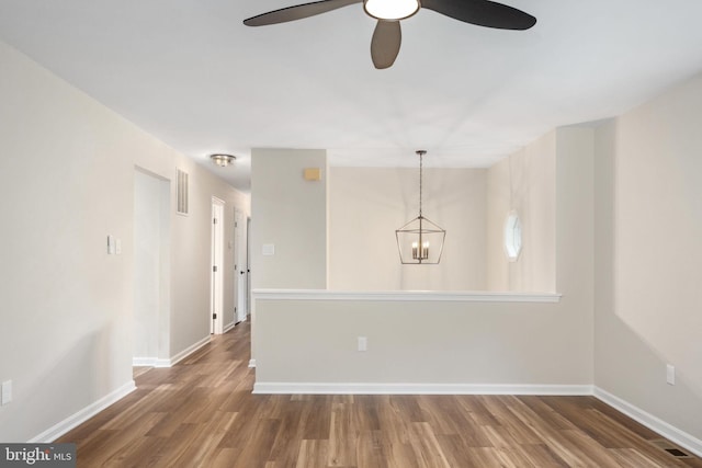 22 Buck Rd, Stafford, VA 22556 - empty room featuring wood finished floors, baseboards, a ceiling fan, and a chandelier