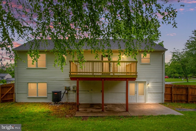 22 Buck Rd, Stafford, VA 22556 - back of house at dusk with a deck, a patio, cooling unit, and brick siding
