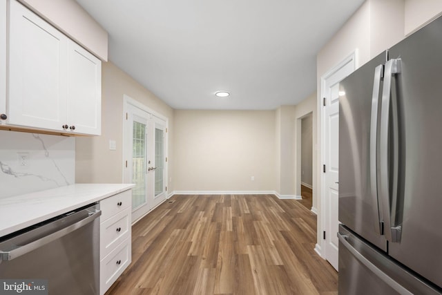 22 Buck Rd, Stafford, VA 22556 - kitchen with appliances with stainless steel finishes, white cabinets, wood finished floors, baseboards, and recessed lighting
