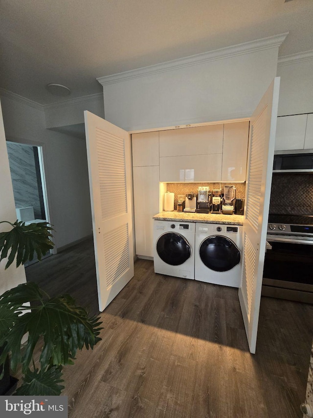 1211 S Eads St Unit 1701, Arlington, VA 22202 - laundry room with ornamental molding, separate washer and dryer, and dark wood-type flooring