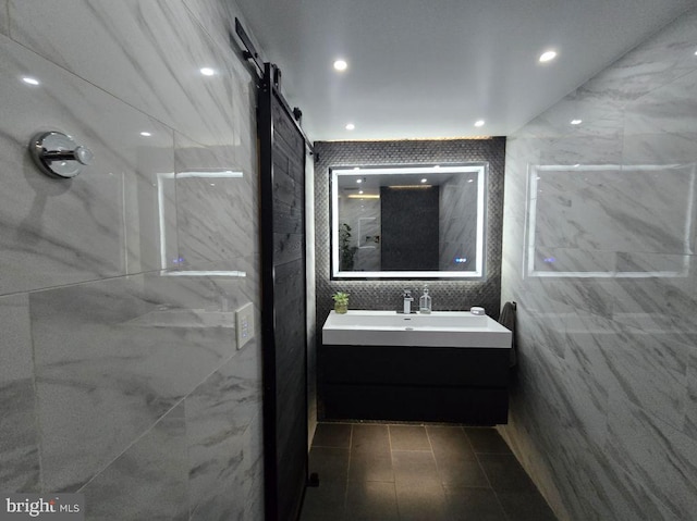 1211 S Eads St Unit 1701, Arlington, VA 22202 - bathroom featuring vanity, tile walls, a marble finish shower, tile patterned flooring, and recessed lighting