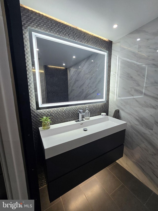 1211 S Eads St Unit 1701, Arlington, VA 22202 - bathroom featuring tile walls, vanity, recessed lighting, and tile patterned floors