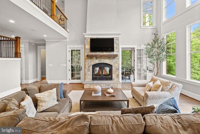 1601 E Ave, Mclean, VA 22101 - living area with a high ceiling, a stone fireplace, baseboards, plenty of natural light, and wood finished floors