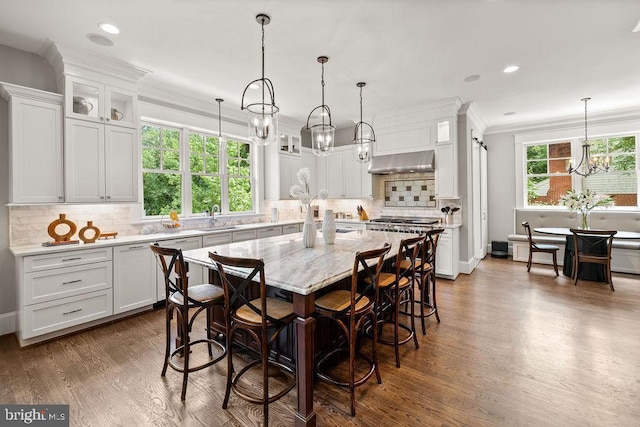 1601 E Ave, Mclean, VA 22101 - kitchen featuring a chandelier, ventilation hood, dark wood finished floors, glass insert cabinets, and ornamental molding