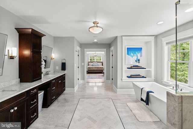 1601 E Ave, Mclean, VA 22101 - full bathroom with a soaking tub, connected bathroom, double vanity, baseboards, and recessed lighting