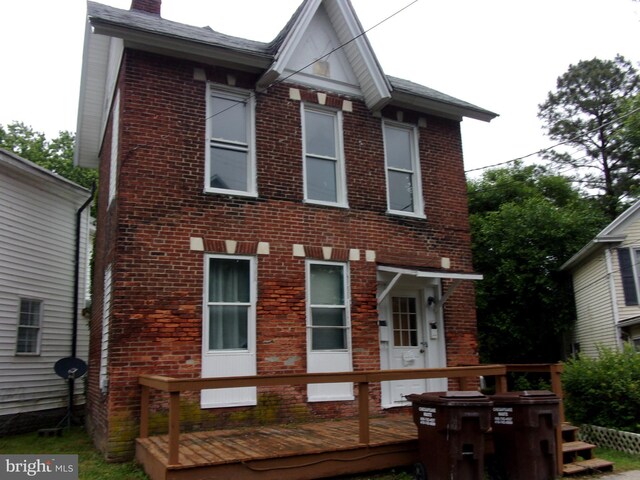 204 Hayward St, Cambridge, MD 21613 - rear view of house with brick siding, a wooden deck, and a chimney