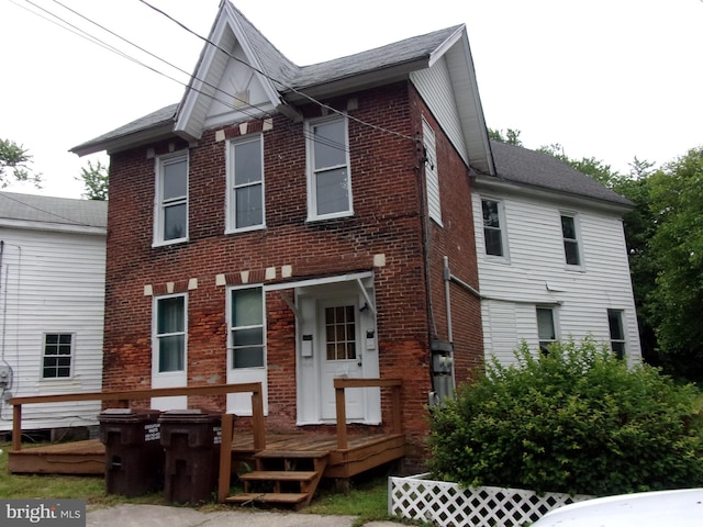 204 Hayward St, Cambridge, MD 21613 - view of front of home with brick siding and a wooden deck