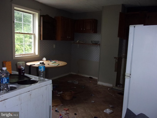 204 Hayward St, Cambridge, MD 21613 - kitchen featuring freestanding refrigerator, decorative backsplash, plenty of natural light, and tile patterned flooring