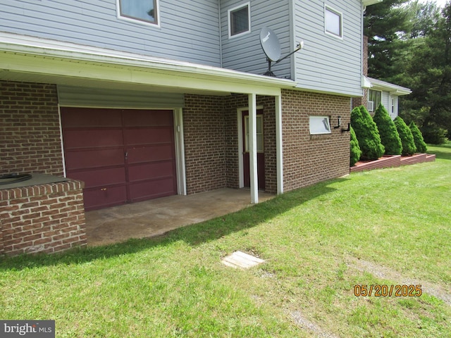 410 Pine Glen Rd, Moshannon, PA 16859 - view of side of home featuring a lawn, brick siding, and an attached garage