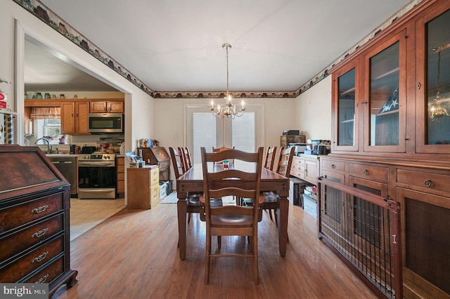 24519 Cedar Ln, Georgetown, DE 19947 - dining space featuring a chandelier and wood finished floors
