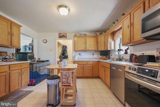 24519 Cedar Ln, Georgetown, DE 19947 - kitchen with stainless steel appliances, light countertops, a sink, and light floors