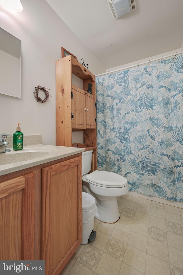 24519 Cedar Ln, Georgetown, DE 19947 - bathroom with toilet, vanity, tile patterned floors, and curtained shower