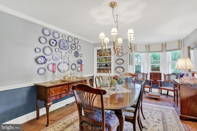 2538 Church Ln, Doylestown, PA 18902 - dining room featuring a chandelier, wood finished floors, crown molding, and baseboards
