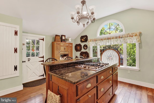 2538 Church Ln, Doylestown, PA 18902 - kitchen with lofted ceiling, baseboards, hardwood / wood-style flooring, brown cabinetry, and gas cooktop