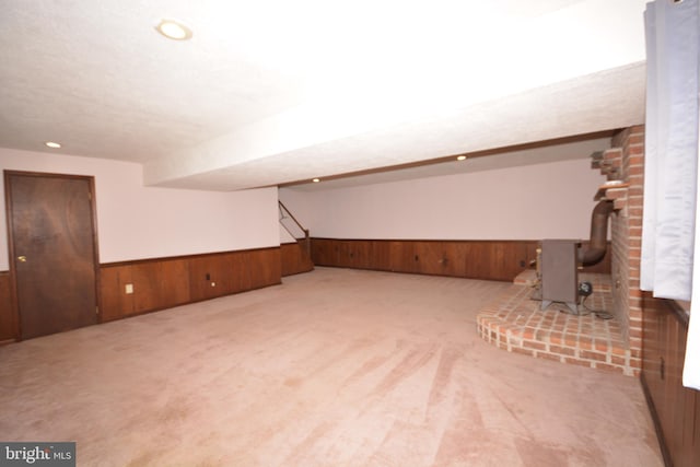 10 Eastbrooke Dr, Ephrata, PA 17522 - bonus room with wooden walls, wainscoting, carpet floors, a wood stove, and recessed lighting