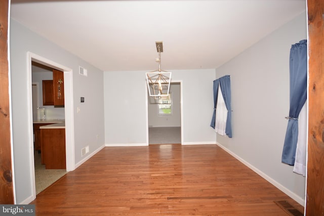 10 Eastbrooke Dr, Ephrata, PA 17522 - empty room with light wood-style floors, a chandelier, and baseboards