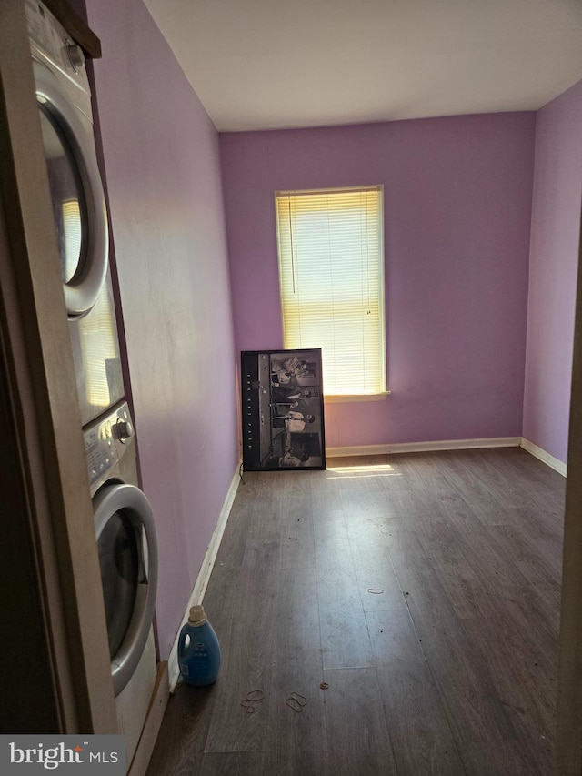 1151 E King St, York, PA 17403 - laundry room featuring estacked washer and dryer, wood finished floors, and baseboards