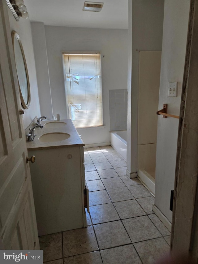 1151 E King St, York, PA 17403 - bathroom with tile patterned floors, double vanity, and a tub