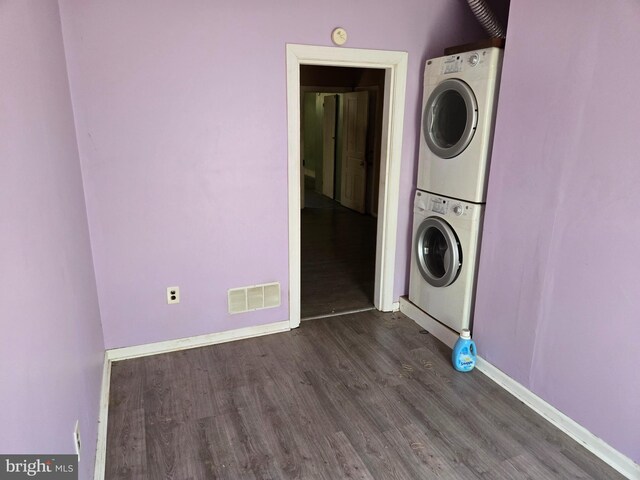 1151 E King St, York, PA 17403 - laundry area featuring estacked washer and dryer, dark wood finished floors, and baseboards