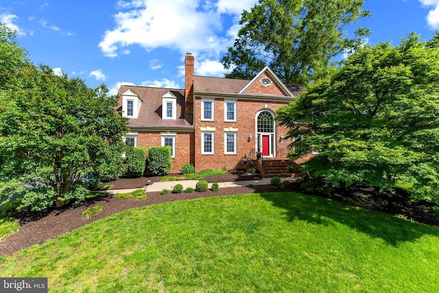2200 Traies Ct, Alexandria, VA 22306 - colonial-style house with a chimney, brick siding, and a front yard
