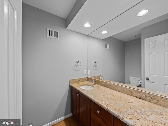2200 Traies Ct, Alexandria, VA 22306 - bathroom with vanity, baseboards, toilet, wood finished floors, and recessed lighting