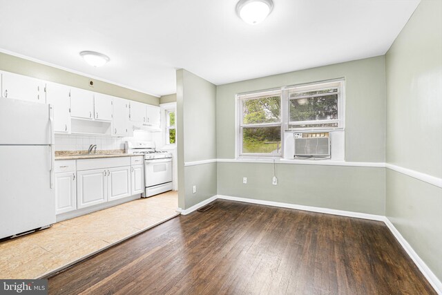 5649 Kavon Ave, Baltimore, MD 21206 - kitchen with white appliances, dark wood-type flooring, baseboards, a sink, and white cabinets