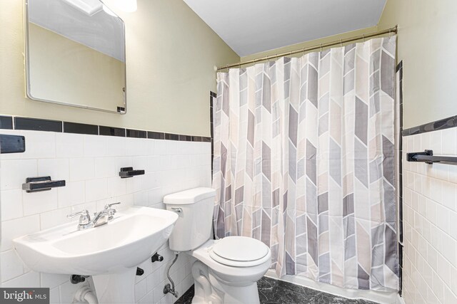 5649 Kavon Ave, Baltimore, MD 21206 - bathroom with tile walls, toilet, marble finish flooring, a wainscoted wall, and a shower with curtain