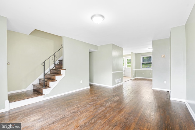 5649 Kavon Ave, Baltimore, MD 21206 - unfurnished living room featuring wood finished floors, stairway, and baseboards
