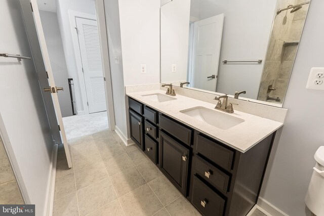 14438 Mattawoman Dr Unit 5000H, Brandywine, MD 20613 - full bath with double vanity, tile patterned flooring, toilet, tiled shower, and baseboards